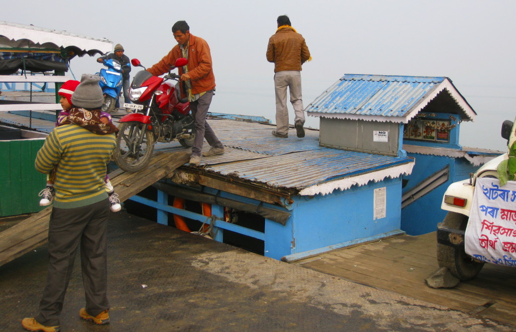 Motorcycles parked on roof of Majuli ferry. Note single rock bracing base of car tire for 90 minute river trip 