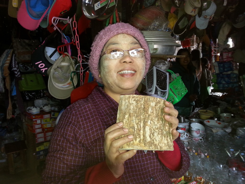 Notice traditional cream from Thanaka bark on her cheeks: used over 2,000 years to cool and refresh the skin. 