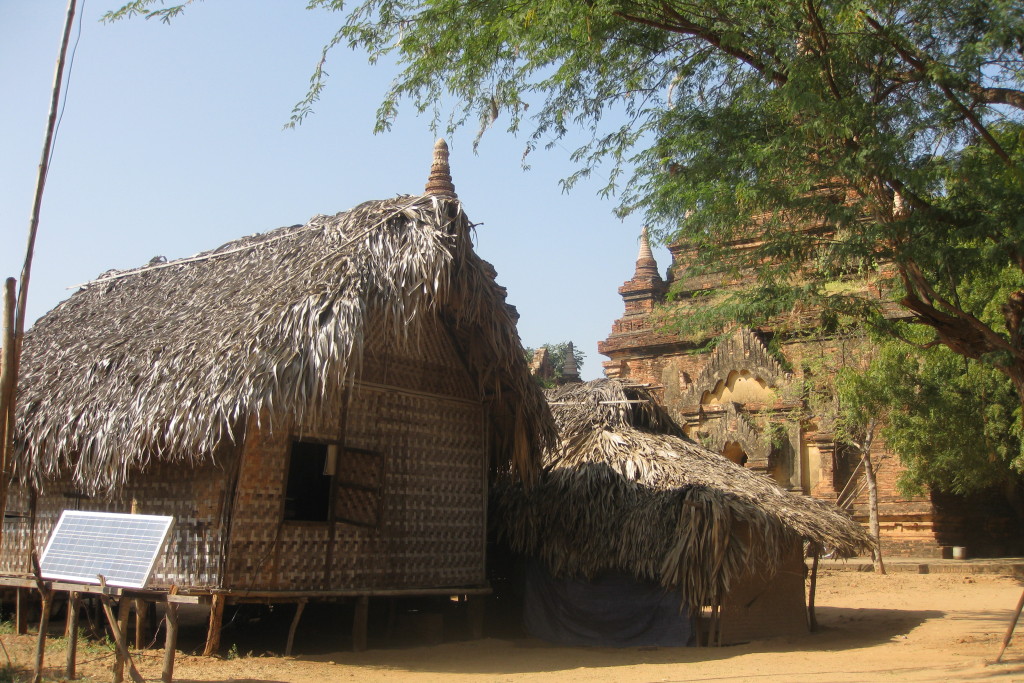 Caretakers basha with solar power adjacent to pagoda with less visitors. 